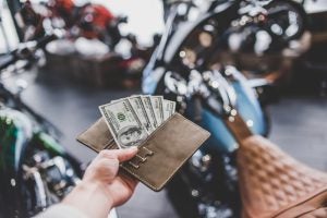 Motorcyclists are faced with ever-increasing fees, charges and mark-ups these days, and it's going to cost the industry long-term. Photo: 4 PM production/Shutterstock.com